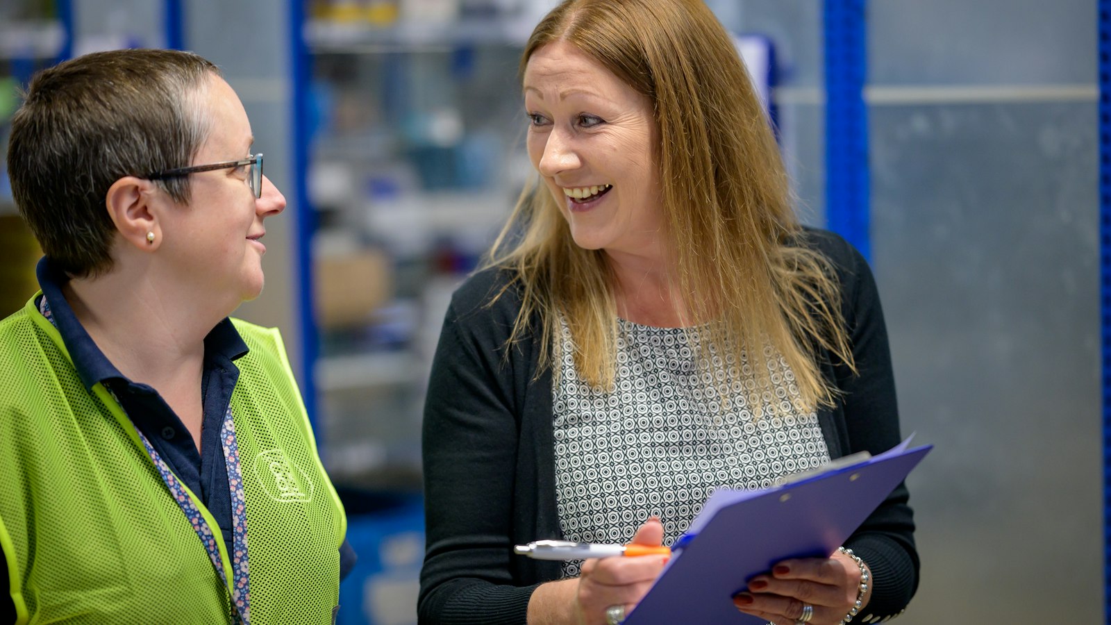 Two warehouse staff reviewing a clipboard checklist of delivered goods, the inventory a reclamation letter demands back